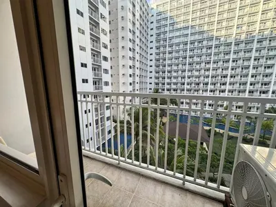 a balcony with a view of a large building at Shore Residences Banana Room with 2 Beds Good for 4 Guests Pool View Room 622 by Prime Stay in Manila