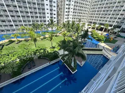 an overhead view of a swimming pool with palm trees and buildings at Shore Residences near Airport Blueberry Room 2 Beds Pool View by Prime Stay Room 628 in Manila