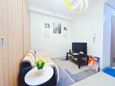 a living room with a couch and a table at SHORE 2 TOWER 2 NEAR MOA 16TH Floor in Manila