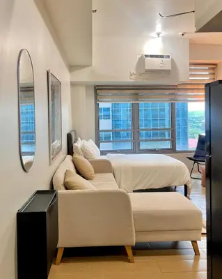a living room with two beds and a couch at Pod to Go in Manila