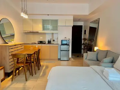 a kitchen and living room with a couch and a table at Pod to Go in Manila