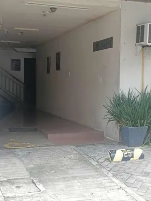 an empty hallway of a building with a potted plant at Deviente's Guesthouse in Manila