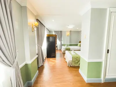 a corridor of a hotel room with a living room at Miramar Hotel in Manila