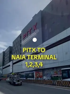 a building with a sign that says pizza to naja terminal at Sybay suites beside okada manila near AirPort MOA COD MSV1807H in Manila