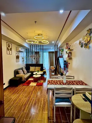 a living room with a couch and a table at Sybay suites beside okada manila near AirPort MOA COD MSV1807H in Manila