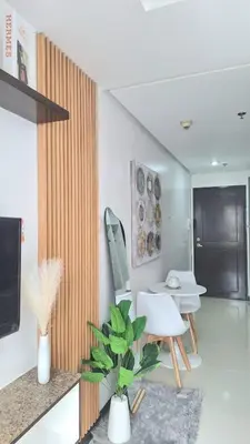 a living room with a table and chairs and a plant at Birch Tower Big Studio Type Unit 2711 in Manila