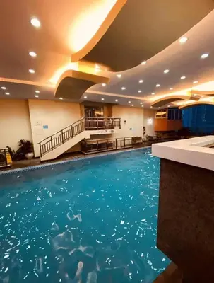 a large swimming pool in a hotel room at Birch Tower Big Studio Type Unit 2711 in Manila