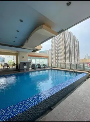 a large swimming pool on the roof of a building at Birch Tower Big Studio Type Unit 2711 in Manila