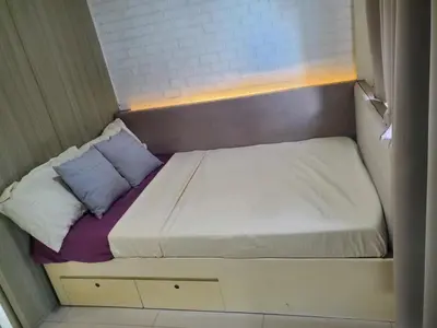 a small bed in a small room at La Luz - SMDC Breeze Residences in Manila