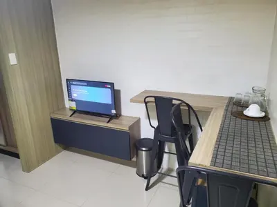 a room with a desk with a laptop computer on it at La Luz - SMDC Breeze Residences in Manila