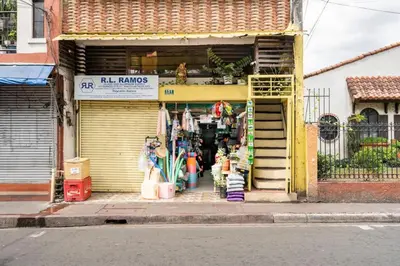 a store front of a store with a yellow door at Economy Room with Private Bath near LRT Santolan Pasig in Manila