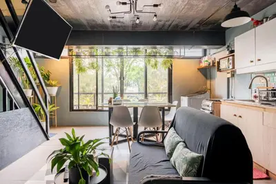 a kitchen and living room with a couch and a table at Economy Room with Private Bath near LRT Santolan Pasig in Manila