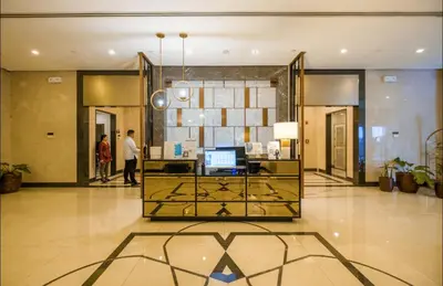 a lobby with a reception desk in a building at AdahkuMaya Luxury Suites in Manila