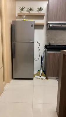 a kitchen with a stainless steel refrigerator in a room at The Olive Place, Manadaluyong City in Manila
