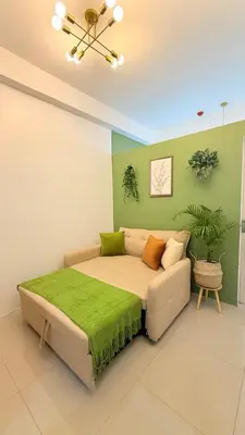 a bedroom with a bed and a green wall at Harbour Park Residences Cozy 1BR Suite in Manila