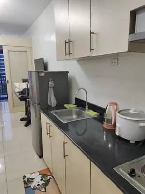 a kitchen with a sink and a refrigerator at Sea Residences Crisha in Manila