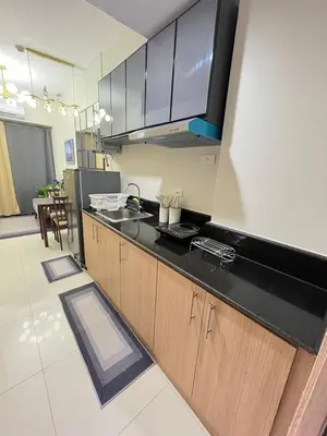 a kitchen with a sink and a counter top at Amber's Crib in Manila