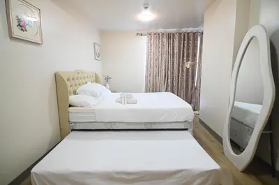 a hospital room with two beds and a window at Kuya Awens Staycation in Manila