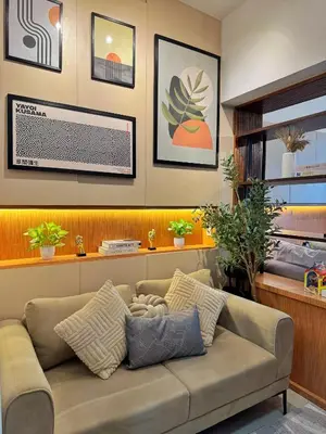 a living room with a couch and some plants at 1-BR condo unit near Rockwell, Poblacion in Manila