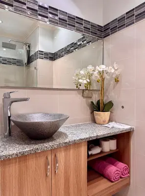 a bathroom with a sink and a mirror at Charming Unit at Smdc Sun Residences in Manila
