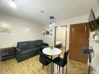 a living room with a couch and a table at Your Comfort Zone Staycation3 in Manila