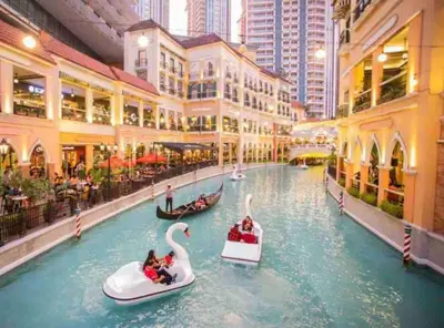 a mall with two gondolas in a water canal at Luxurious Studio in McKinley Hill with City View in Manila