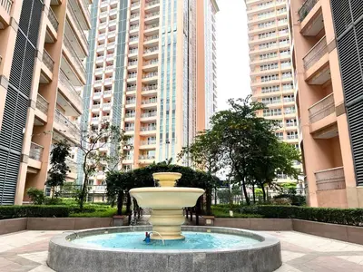 a fountain in the middle of a city with tall buildings at PREMIUM 1BR Venice Canal Mall, Pool, Gym, Sauna & 5G Wi-Fi, Ste 16 in Manila
