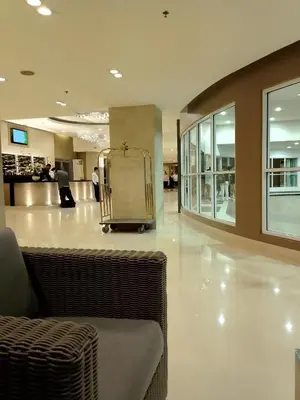a lobby with a luggage cart in a shopping mall at Graxia staycation in Manila
