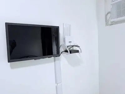 a flat screen tv hanging on a wall at Cozy Place to Stay in Manila