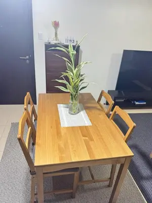 a wooden table with a potted plant on it at City Lights and Cozy nights in Manila