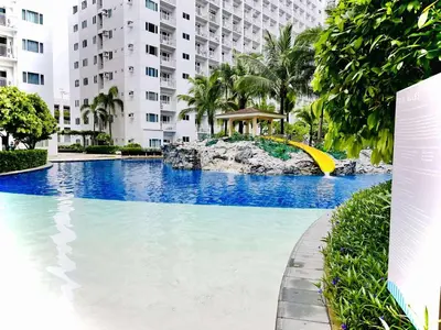 a large swimming pool in front of a building at Shore Residences in Manila