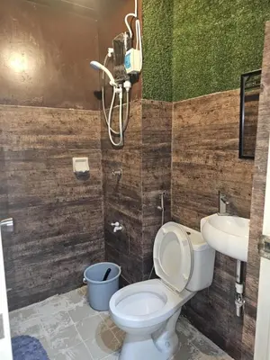 a bathroom with a toilet and a sink at Studio Unit Staycation in Cainta in Cainta
