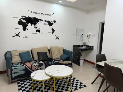 a living room with a couch and a map of the world at 2 AC in 1 Room JCAL Building Near Manila Airports MOA OKADA in Manila