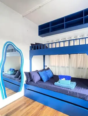 a bunk bed with blue bunk beds in a room at Staycation in Valley Golf near Antipolo in Cainta