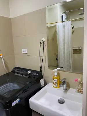 a bathroom with a sink and a stove at CabinandCo in Manila