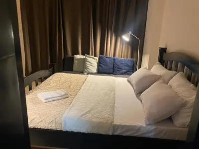 a large bed with white sheets and pillows at 3ms and jacob havens in Manila