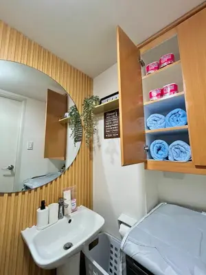 a bathroom with a sink and a mirror at J&J Havenstay Ananda Square in Manila