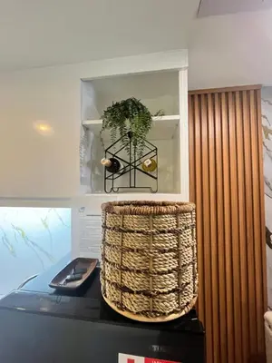 a plant in a basket sitting on top of a table at J&J Havenstay Ananda Square in Manila