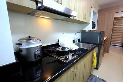 a kitchen with a coffee maker on a counter at Modern Living 6 - MOA Pasay with Wifi and Netflix in Manila
