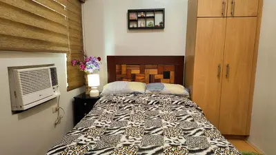 a bedroom with a large bed in a room at Monitor Gear Residences in Manila