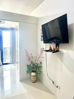a living room with a flat screen tv on a wall at V&G Staycation in Manila