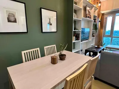 a dining room with a table with chairs and a desk at 55-SQM 1-BR golf club view condo in Central BGC in Manila