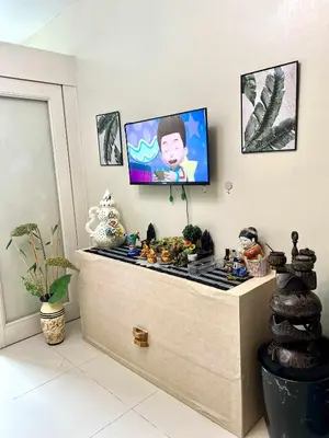 a room with a flat screen tv on a wall at Vince era staycation in Manila