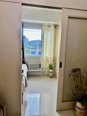 an open door to a room with a window at Vince era staycation in Manila