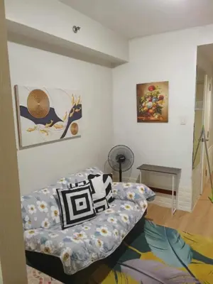a living room with a couch and a table at Rhon's Staycation in Manila