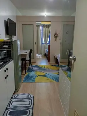 a room with a kitchen and a living room at Rhon's Staycation in Manila