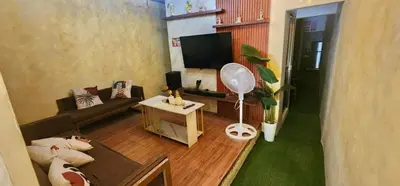 a living room with a couch and a flat screen tv at Cozy Villa with Dipping Pool in Bacoor