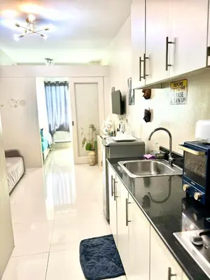a kitchen with a sink and a counter top at V&G era staycation in Manila