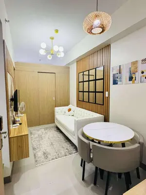 a room with a bed and a table and chairs at Bloom Residence by SMDC in Manila