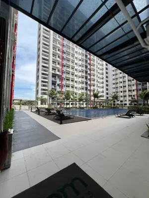a view of a large building with tables and benches at Bloom Residence by SMDC in Manila